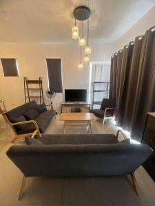 a living room with a couch and chairs and a table at Deluxe Cozy Corner Studio in Minglanilla