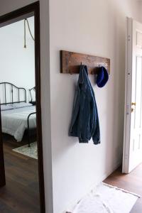 a room with a coat rack and a bed at Casa Delisa in Ceggia