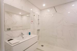a white bathroom with a sink and a shower at Best Houses 104 - Supertubos Beach Apartment in Atouguia da Baleia +32 photos