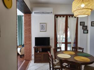 a dining room with a table and a television at Amici di Calabria in Scalea