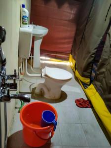 a bathroom with a toilet in a tent at Tyakshi Summer Camp in Nubra