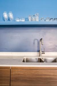 a kitchen counter with a sink and wine glasses at Downtown Penthouse with Private Rooftop #2S in Chicago