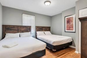 a bedroom with two beds and a window at Settle into Soulard 6 Bedrooms 4 full baths in Soulard