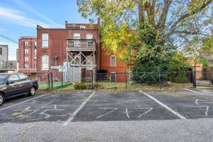 an empty parking lot in front of a brick building at Settle into Soulard 6 Bedrooms 4 full baths in Soulard