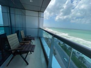 a balcony with chairs and a view of the ocean at Luxurious Sea View - Beach Front in Ajman 