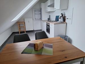 a kitchen with a wooden table and chairs in a room at Moderne Wohnung in Krefeld in Krefeld