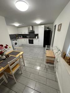 a kitchen with a table and a dining room at Beautiful 1-Bed Apartment in Colchester in Colchester