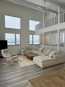 a living room with a white couch and a chair at Mountain Villa ニセコ in Kutchan