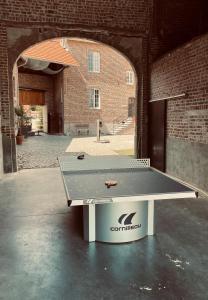 - une table de ping-pong à l'intérieur d'un bâtiment dans l'établissement Villa de Daelhoeve luxurious with big garden, à Heers