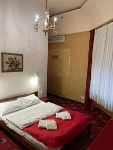 a bedroom with a bed with two towels on it at Mini Hotel Central Park in Lviv