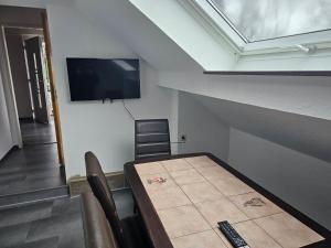 a room with a table and a flat screen tv at Ferienwohnung im Besigheim in Besigheim