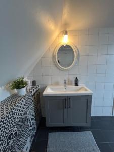 a bathroom with a sink and a mirror at Kungshagagård in Höllviken