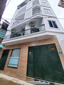 a building with a green door in front of it at Dodo home AC in Hanoi