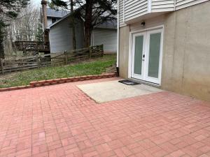 a house with a door and a brick driveway at Garden's Grace: Whispers in Silver Spring