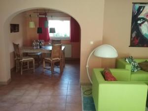 a living room with a green couch and a table at Landhaus Lucia 2 in Oberau