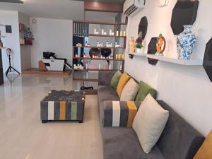 a living room with a couch and a table at HOTEL AARNA in Tezpur