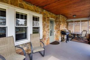 a screened in porch with chairs and a grill at St Petersburg Cottage with Porch, 2 Mi to Foxburg! in Emlenton