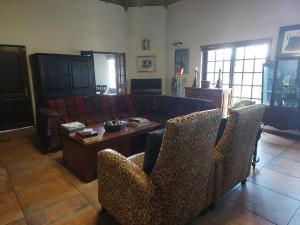 a living room with a couch and a table at Garrett Guest House in Pretoria