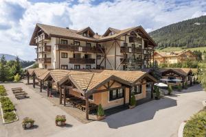 an aerial view of a resort with a building at Golf Hotel in Folgaria