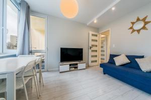 Televízia a/alebo spoločenská miestnosť v ubytovaní Warsaw Concierge Silver Apartment