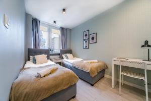 Posteľ alebo postele v izbe v ubytovaní Warsaw Concierge Silver Apartment