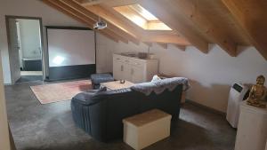 a living room with a couch and a projection screen at FeWoHerrmann in Gundelsheim