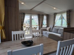 a living room with a couch and a table at The Ardennes 66 in Dunoon