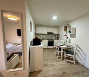 a small kitchen and dining room with a table and chairs at Ferienwohnungen GoJa in Bad Königshofen im Grabfeld