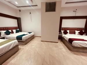 um quarto com duas camas num quarto em The Solitaire Express Vrindavan em Vrindavan