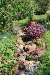 a garden with rocks and flowers in a yard at Fewo Odenwald - Marie in Breuberg