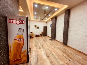 a coca cola sign in a room with a soda machine at The Solitaire Express Vrindavan in Vrindāvan