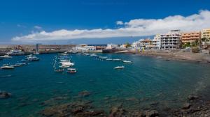 a group of boats in the water near a beach at Apartamentos Charco del Conde in Valle Gran Rey