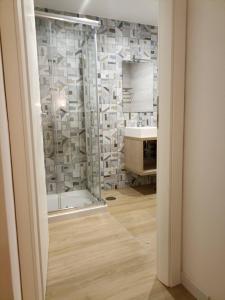 a bathroom with a shower and a sink at Monteoliveto 5 in Naples