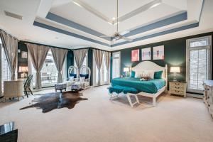 Schlafzimmer mit einem Bett mit grüner Tagesdecke in der Unterkunft Luxury Lakefront Vacation Villa about 29 Mi to Atlanta 