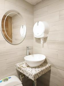 a bathroom with a sink and a mirror and a toilet at Cabañas covemar in Coveñas