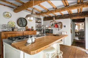 a kitchen with a wooden counter top and a stove at Villa mulino del 500 in Carmignano