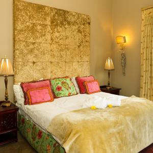 a bedroom with a large bed with pillows on it at Country Retreat in Magaliesburg in Magaliesburg