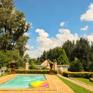 a swimming pool with a toy in the yard at Country Retreat in Magaliesburg in Magaliesburg