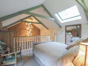 a bedroom with a bed and a skylight at Fronlefrith Llangrannog in Blaencelyn