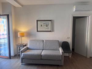 a living room with a couch and a table and a lamp at Monolocale Mezzocammino in Mostacciano