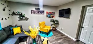 a living room with a couch and a yellow chair at Cozy Nashville Duplex Unit B in Nashville