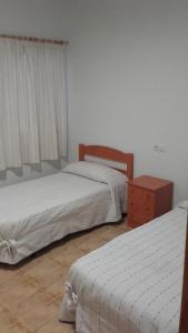Posteľ alebo postele v izbe v ubytovaní Hostal Virgen Del Pilar