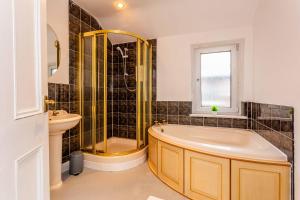 a bathroom with a tub and a sink at Wonderful House near the Castle in Haltwhistle