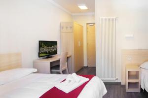 Postel nebo postele na pokoji v ubytování Hotel Croda Rossa
