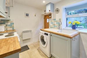 a kitchen with a washing machine and a sink at Host & Stay - Claire's Cottage in Kent
