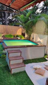 a swimming pool with stairs and a trampoline at EKO STAY - Solace Villa I Charming Villa close to Candolim Beach in Marmagao