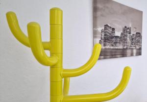 a yellow cactus sculpture in front of a painting at The Penthouse NY Loft Apartment in Barmouth