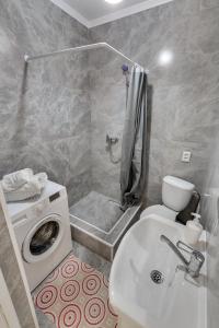 a bathroom with a washing machine and a sink at City Plus 285/8 in Almaty