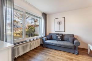 a living room with a couch and a large window at Ferienwohnung Greitemann in Eslohe