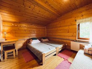 Habitación con cama en una cabaña de madera en Chata pod Jaworem, en Wisła